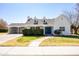 Charming home featuring a bright blue front door, manicured hedges, and a covered carport at 713 E Eason Ave, Buckeye, AZ 85326