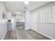 Bright hallway with neutral tones and modern flooring leading into the kitchen at 713 E Eason Ave, Buckeye, AZ 85326