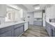 Bright kitchen featuring white countertops, undermount sink, white appliances, grey lower cabinets, and wood-look flooring at 713 E Eason Ave, Buckeye, AZ 85326