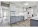 Traditional-style kitchen with white cabinets and oven range, grey lower cabinets, and wood-look flooring at 713 E Eason Ave, Buckeye, AZ 85326