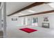 Spacious living room featuring exposed wood beams and ample natural light from the sliding glass doors at 713 E Eason Ave, Buckeye, AZ 85326