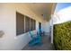 Cozy front porch with blue Adirondack chairs, perfect for relaxing outdoors at 713 E Eason Ave, Buckeye, AZ 85326