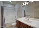 Cozy bathroom featuring a shower-tub combo, and a wooden vanity with ample counter space at 725 W Hermosa Dr, Wickenburg, AZ 85390