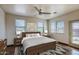 Cozy bedroom with neutral colors, modern ceiling fan, and natural light at 725 W Hermosa Dr, Wickenburg, AZ 85390