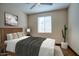 Well-lit bedroom with ceiling fan, natural light, and hardwood floors at 725 W Hermosa Dr, Wickenburg, AZ 85390