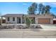 Charming single-story home featuring desert landscaping and an attached two-car garage at 725 W Hermosa Dr, Wickenburg, AZ 85390