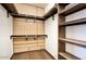 Spacious walk-in closet featuring custom shelving and wooden accents for optimal storage and organization at 725 W Hermosa Dr, Wickenburg, AZ 85390