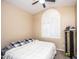 Bedroom with arched window, white shutters, neutral wall color, and carpet flooring at 7365 W Via Del Sol Dr, Glendale, AZ 85310