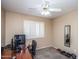 Functional bedroom space with a desk, shutters on the window, and weights for a home gym at 7365 W Via Del Sol Dr, Glendale, AZ 85310