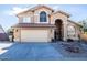 Charming home featuring a two-car garage and desert landscaping at 7365 W Via Del Sol Dr, Glendale, AZ 85310