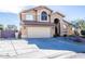 Charming home featuring a two-car garage and desert landscaping at 7365 W Via Del Sol Dr, Glendale, AZ 85310