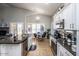 Bright kitchen with white cabinets, black counters, and a breakfast table at 7365 W Via Del Sol Dr, Glendale, AZ 85310