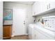 Laundry room featuring a washer and dryer, white cabinets, and neutral wall color at 7365 W Via Del Sol Dr, Glendale, AZ 85310