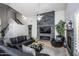 Open concept living room with a stone accent wall, fireplace, and modern furniture at 7365 W Via Del Sol Dr, Glendale, AZ 85310