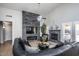 Spacious living room with a stone accent wall, fireplace, and modern furniture at 7365 W Via Del Sol Dr, Glendale, AZ 85310