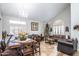 A spacious living room with tile floors, bright windows, a Christmas tree, and decorative seating at 7365 W Via Del Sol Dr, Glendale, AZ 85310