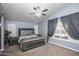 Bedroom with neutral color walls, decorative window, and carpet flooring at 7365 W Via Del Sol Dr, Glendale, AZ 85310