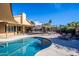 Outdoor pool and patio area with lounging chairs and shaded seating under a clear blue sky at 7365 W Via Del Sol Dr, Glendale, AZ 85310