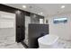 Modern bathroom featuring a freestanding tub, glass shower, and marble floors at 743 E Sierra Vista Dr, Phoenix, AZ 85014