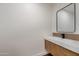 Modern bathroom vanity with sleek countertop, wood cabinets, and a mirror at 743 E Sierra Vista Dr, Phoenix, AZ 85014