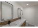 Modern bathroom featuring a dual sink vanity with sleek black faucets and minimalist pendant lighting at 743 E Sierra Vista Dr, Phoenix, AZ 85014