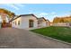 Contemporary home with white exterior, gravel driveway, and lush green lawn under a clear blue sky at 743 E Sierra Vista Dr, Phoenix, AZ 85014