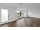 Bright living room with hardwood floors, white walls, and a large window offering views of the neighborhood at 743 E Sierra Vista Dr, Phoenix, AZ 85014