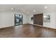 Bright living room with wood floors, large sliding glass door, and accent wall at 743 E Sierra Vista Dr, Phoenix, AZ 85014