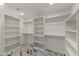 Spacious walk-in closet with built-in shelving and marble floors at 743 E Sierra Vista Dr, Phoenix, AZ 85014