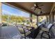 Inviting covered patio area featuring a dining table, fire pit, and comfortable seating for outdoor relaxation at 7952 E Teton Cir, Mesa, AZ 85207