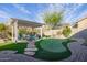 Beautiful backyard with a covered seating area and putting green, ideal for outdoor relaxation and entertainment at 7952 E Teton Cir, Mesa, AZ 85207