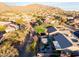 Perfect for entertaining, this backyard boasts a putting green, patio, and desert landscaping at 7952 E Teton Cir, Mesa, AZ 85207