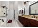 Elegant bathroom featuring dark wood cabinets, granite countertops, and a glass-enclosed shower at 7952 E Teton Cir, Mesa, AZ 85207