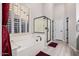 Bright bathroom features a soaking tub with plantation shutters and a glass-enclosed shower at 7952 E Teton Cir, Mesa, AZ 85207