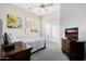 Another bedroom includes a ceiling fan, a bed, sliding-door closet and shuttered windows at 7952 E Teton Cir, Mesa, AZ 85207