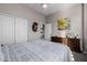 Bedroom features a ceiling fan, sliding-door closet, wood dresser, and picture art at 7952 E Teton Cir, Mesa, AZ 85207