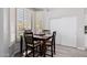 Cozy dining area featuring a dark wood table set, shuttered windows, and wood-look flooring at 7952 E Teton Cir, Mesa, AZ 85207