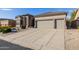 Home featuring a three-car garage with a long driveway at 7952 E Teton Cir, Mesa, AZ 85207