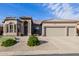 Charming home featuring a three-car garage and beautifully landscaped front yard at 7952 E Teton Cir, Mesa, AZ 85207