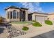 Charming home featuring a three-car garage and beautifully landscaped front yard at 7952 E Teton Cir, Mesa, AZ 85207