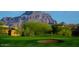 Green golf course view features rugged mountain in the background at 7952 E Teton Cir, Mesa, AZ 85207