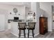 Bright kitchen with white cabinets, mosaic backsplash, breakfast bar, and stylish seating at 7952 E Teton Cir, Mesa, AZ 85207