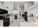 Open-concept kitchen with white cabinetry, mosaic backsplash, and stainless steel appliances at 7952 E Teton Cir, Mesa, AZ 85207