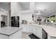 Modern kitchen featuring white cabinets, mosaic backsplash, and a black refrigerator at 7952 E Teton Cir, Mesa, AZ 85207