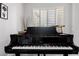 Grand piano in the living room with lots of natural light at 7952 E Teton Cir, Mesa, AZ 85207