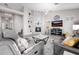 Bright living room featuring a fireplace, vaulted ceilings, and comfortable gray furniture at 7952 E Teton Cir, Mesa, AZ 85207