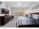 Comfortable main bedroom with a bay window and a TV over a dark dresser at 7952 E Teton Cir, Mesa, AZ 85207