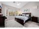 Inviting main bedroom with a bay window, soft carpet, and neutral color palette at 7952 E Teton Cir, Mesa, AZ 85207