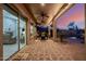 Covered patio with ceiling fans, string lights, and a cozy seating area with a fire pit at 7952 E Teton Cir, Mesa, AZ 85207