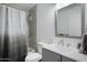 Bathroom featuring a shower with curtain, toilet, sink, and mirror at 815 N Hayden Rd # B109, Scottsdale, AZ 85257